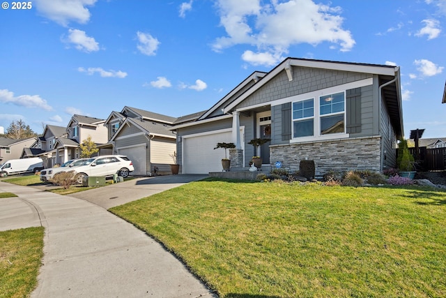 view of front of home with a front lawn, a residential view, driveway, stone siding, and an attached garage