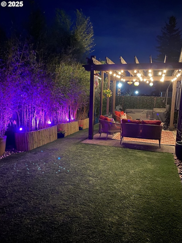 yard at night with an outdoor hangout area and fence