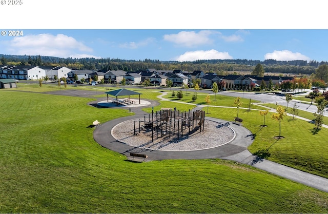 view of home's community with playground community, a residential view, and a lawn