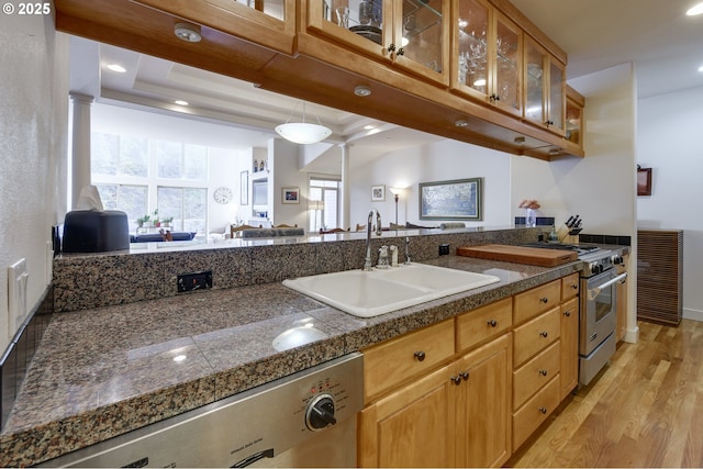 844 SW Broadway Dr Unit 3, Portland, OR 97201 - kitchen with dishwasher, a sink, tile countertops, light wood-style floors, and glass insert cabinets