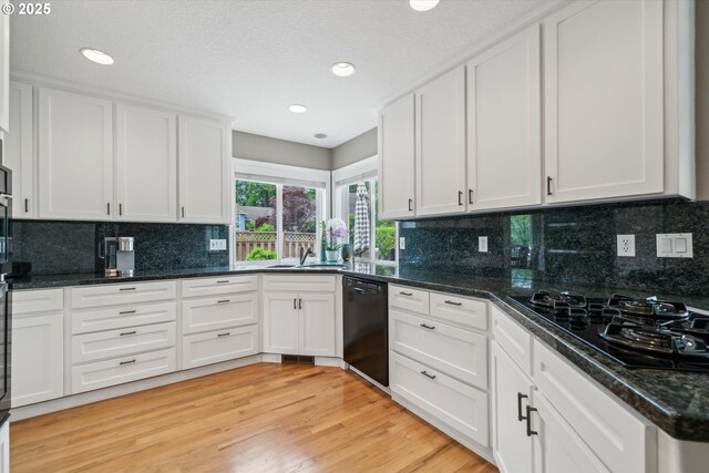 2678 SE Myrtlewood Way, Gresham, OR 97080 - kitchen featuring black appliances, a sink, white cabinets, light wood finished floors, and tasteful backsplash