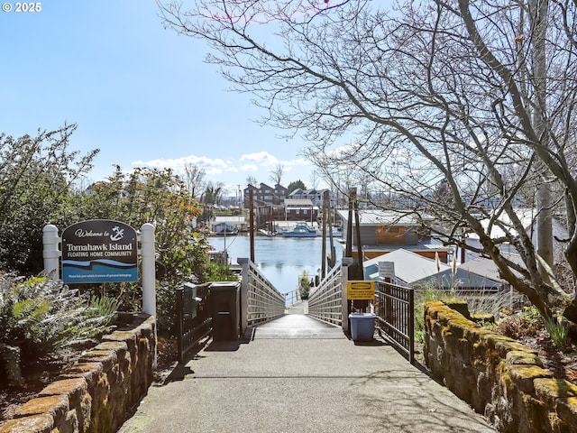 view of home's community featuring a water view and a boat dock