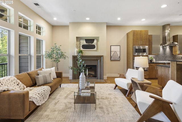 10122 SW Morrison St, Portland, OR 97225 - living room with recessed lighting, a fireplace with flush hearth, and light wood-style flooring