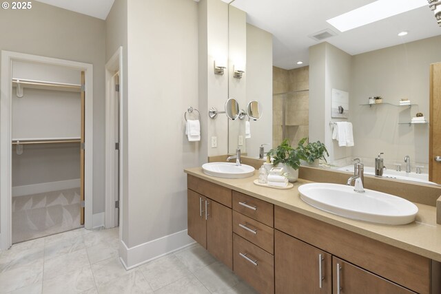 10122 SW Morrison St, Portland, OR 97225 - bathroom with double vanity, a spacious closet, a skylight, a tile shower, and tile patterned flooring