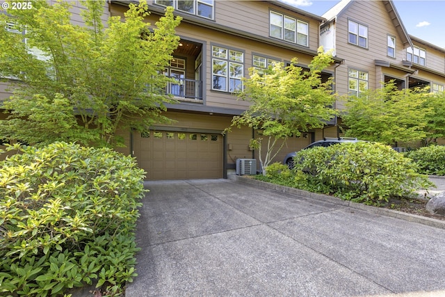 10122 SW Morrison St, Portland, OR 97225 - view of front facade with an attached garage, a balcony, and driveway