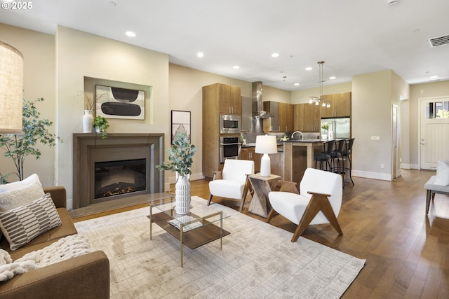 10122 SW Morrison St, Portland, OR 97225 - living room featuring recessed lighting, wood finished floors, and a glass covered fireplace