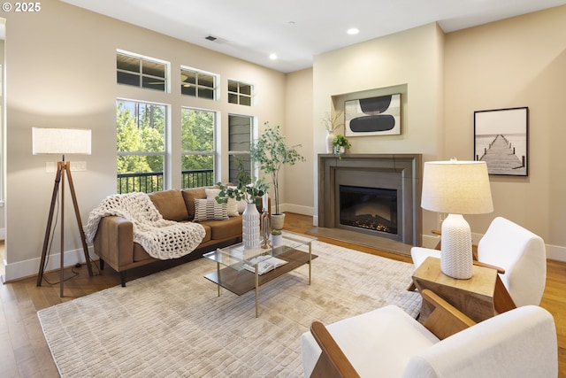 10122 SW Morrison St, Portland, OR 97225 - living room featuring wood finished floors, recessed lighting, and a glass covered fireplace