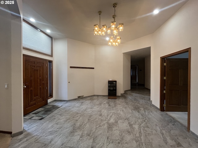 entryway with visible vents, baseboards, a notable chandelier, and recessed lighting