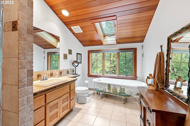 57953 Drury Ln, Blue River, OR 97413 - bathroom with a bathing tub, lofted ceiling with skylight, wooden ceiling, and tile patterned floors