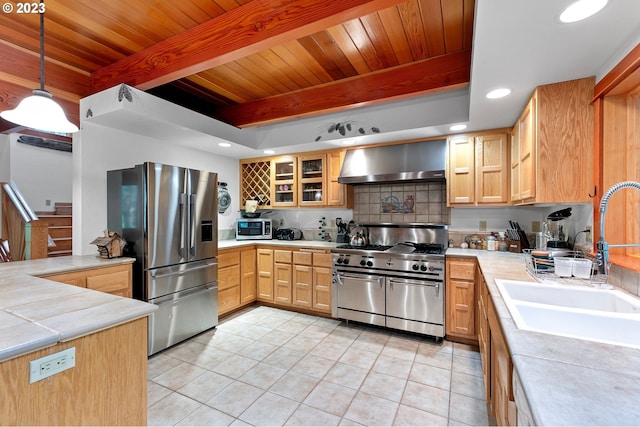 57953 Drury Ln, Blue River, OR 97413 - kitchen featuring decorative light fixtures, beamed ceiling, sink, stainless steel appliances, and wall chimney range hood
