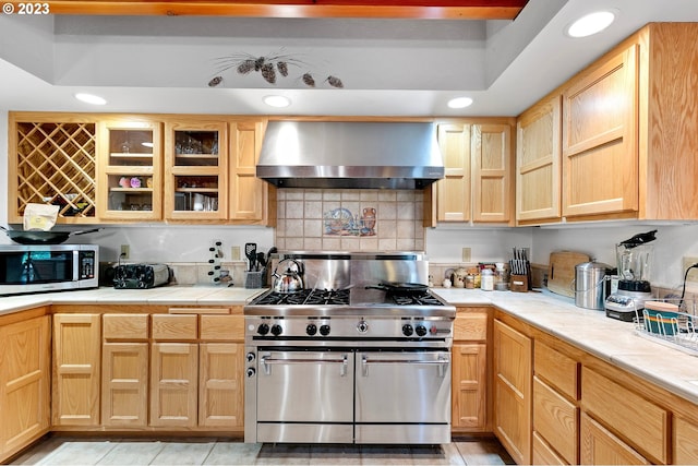 57953 Drury Ln, Blue River, OR 97413 - kitchen with appliances with stainless steel finishes, tasteful backsplash, light brown cabinets, light tile patterned floors, and wall chimney range hood