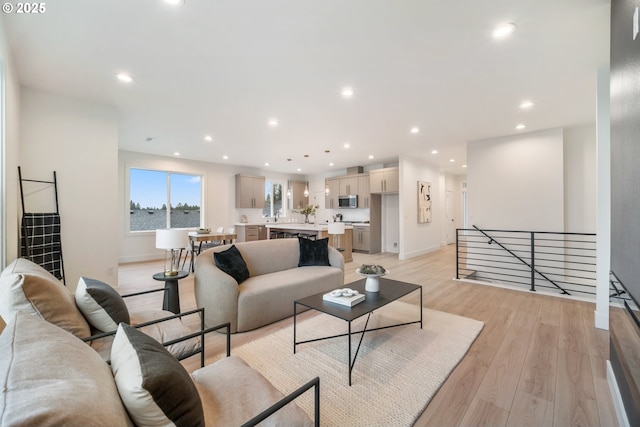 118 W 13th Way, La Center, WA 98629 - living room featuring light wood-style flooring, baseboards, and recessed lighting
