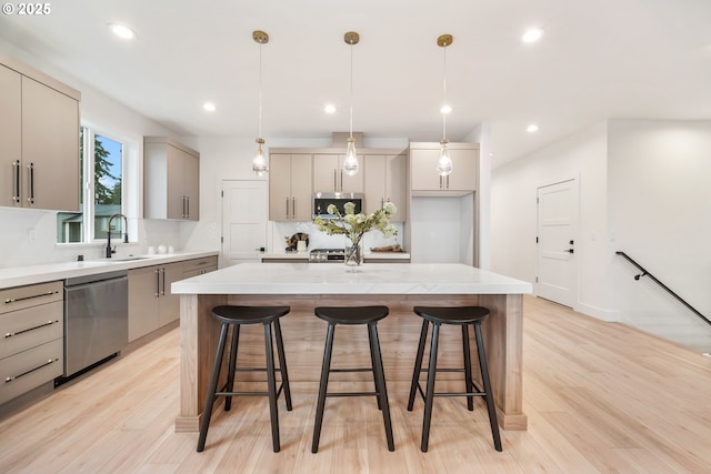 118 W 13th Way, La Center, WA 98629 - kitchen with appliances with stainless steel finishes, a sink, gray cabinets, a center island, and light wood-style flooring