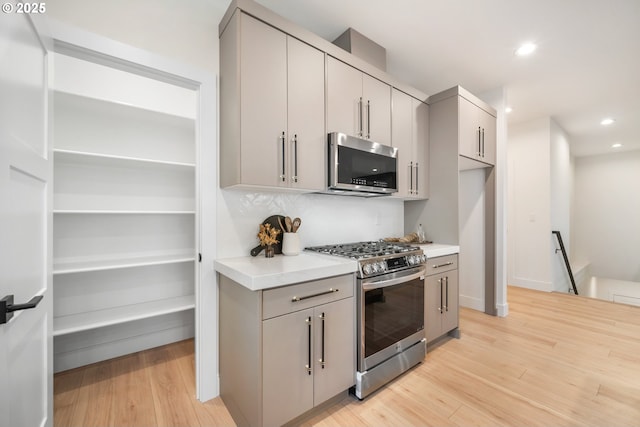 118 W 13th Way, La Center, WA 98629 - kitchen with stainless steel appliances, gray cabinetry, light wood finished floors, recessed lighting, and light countertops