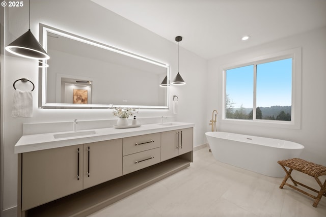 118 W 13th Way, La Center, WA 98629 - bathroom featuring double vanity, a freestanding bath, recessed lighting, baseboards, and tile patterned flooring