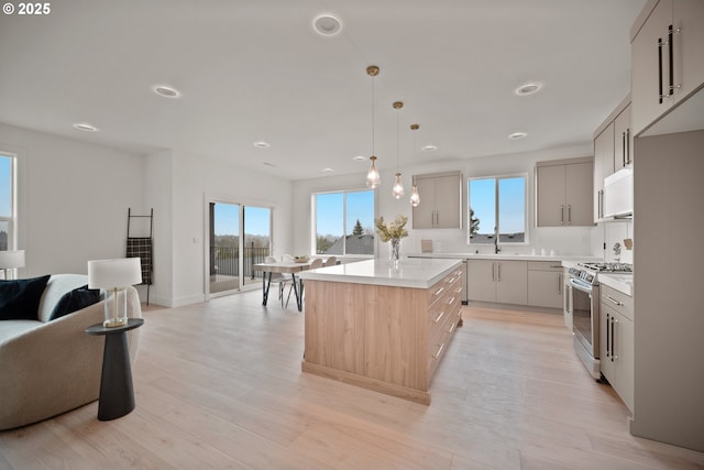 118 W 13th Way, La Center, WA 98629 - kitchen featuring gas stove, open floor plan, light countertops, gray cabinets, and recessed lighting