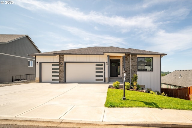 118 W 13th Way, La Center, WA 98629 - view of front of house featuring a garage, driveway, stone siding, and a shingled roof