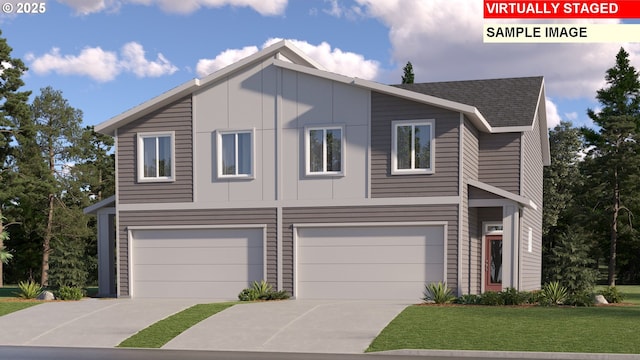 view of front of property with a front yard and a garage