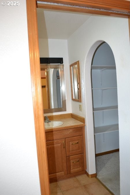 bathroom featuring tile patterned flooring and vanity