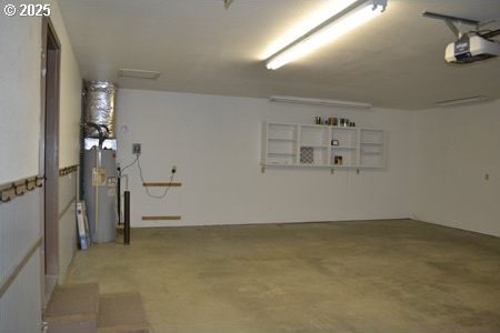 garage featuring a garage door opener and water heater