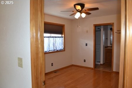unfurnished bedroom featuring baseboards and wood finished floors