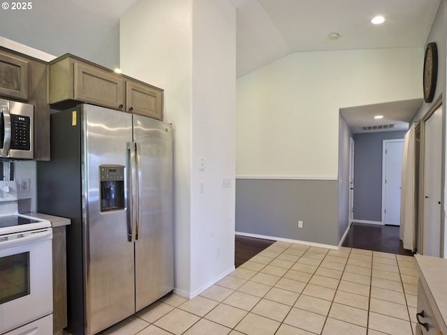503 E Yacolt Rd, Yacolt, WA 98675 - kitchen with appliances with stainless steel finishes, vaulted ceiling, light tile patterned floors, light countertops, and recessed lighting