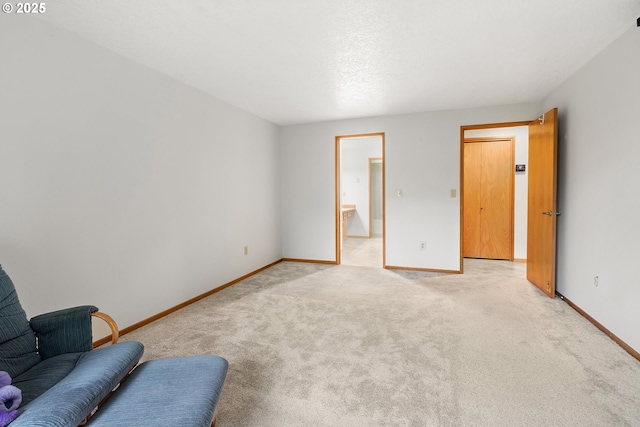 unfurnished room with light carpet and baseboards