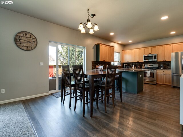 dining room with a chandelier, recessed lighting, dark wood-style floors, and baseboards