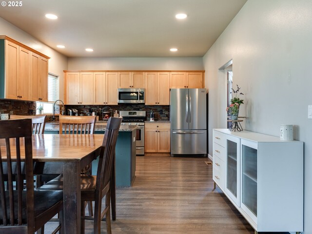 kitchen featuring appliances with stainless steel finishes, light brown cabinets, backsplash, dark wood-style flooring, and recessed lighting