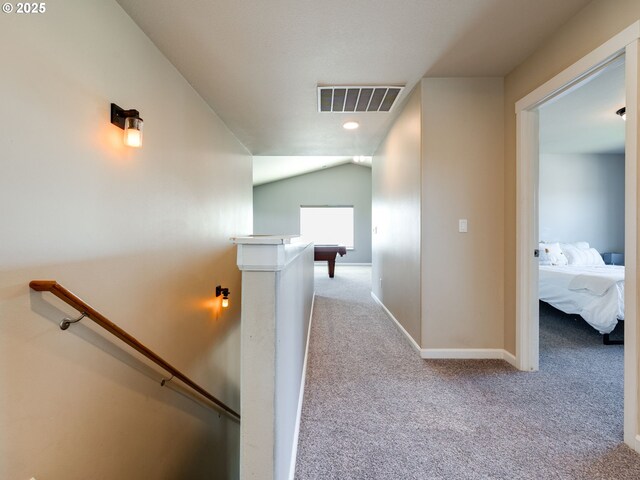 hall with an upstairs landing, carpet floors, baseboards, vaulted ceiling, and recessed lighting