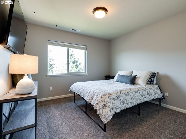 bedroom with baseboards and carpet floors
