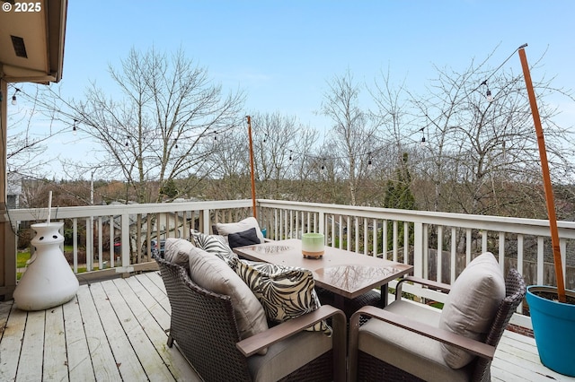 wooden deck featuring outdoor dining space