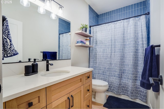 full bath featuring a shower with curtain, toilet, and vanity