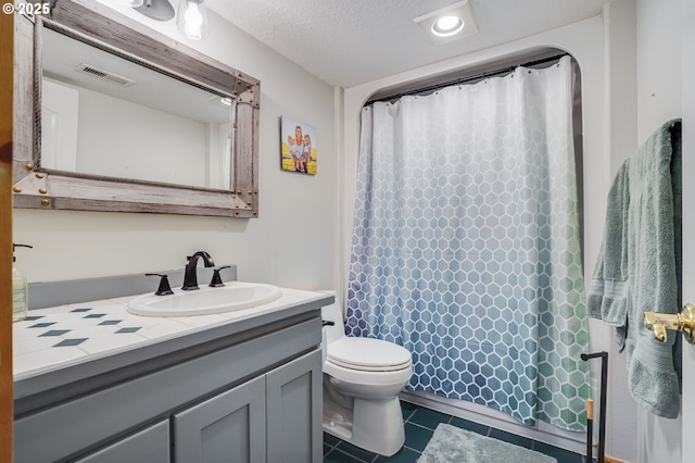 full bath featuring tile patterned flooring, visible vents, toilet, vanity, and a textured ceiling