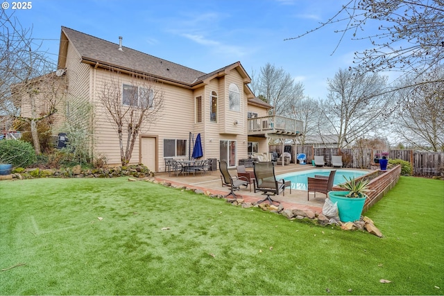 rear view of house with a patio, fence, a fenced in pool, a yard, and a shingled roof