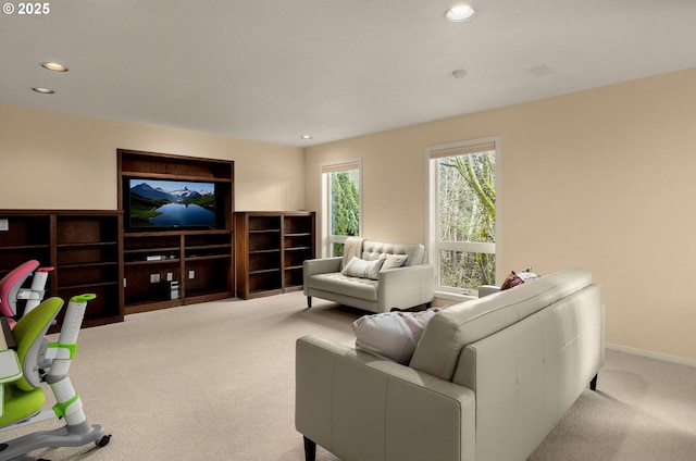 living area featuring recessed lighting, light colored carpet, and baseboards