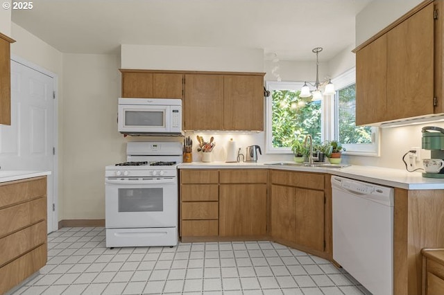 1910 Saginaw St S, Salem, OR 97302 - kitchen with white appliances, a sink, light countertops, pendant lighting, and brown cabinets