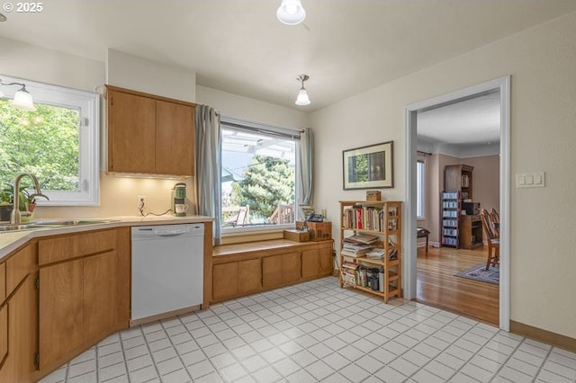 1910 Saginaw St S, Salem, OR 97302 - kitchen featuring dishwasher, light countertops, a sink, pendant lighting, and baseboards