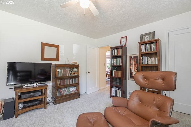 1910 Saginaw St S, Salem, OR 97302 - carpeted living room featuring a textured ceiling, a ceiling fan, and baseboards