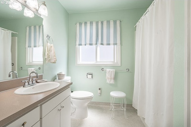 1910 Saginaw St S, Salem, OR 97302 - bathroom with vanity, toilet, healthy amount of natural light, and a shower with curtain