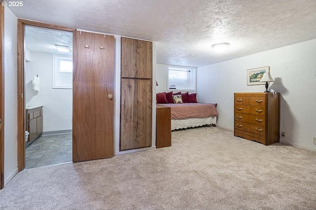 1910 Saginaw St S, Salem, OR 97302 - carpeted bedroom with a textured ceiling, multiple windows, ensuite bathroom, and baseboards