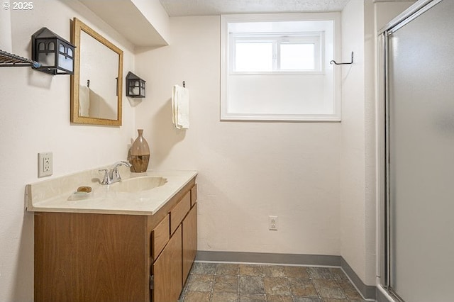1910 Saginaw St S, Salem, OR 97302 - full bathroom with vanity, baseboards, a stall shower, and stone finish floors