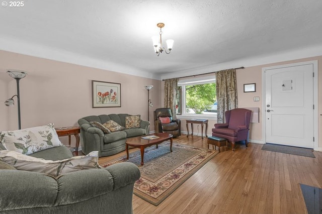 1910 Saginaw St S, Salem, OR 97302 - living area with a chandelier, light wood finished floors, and baseboards