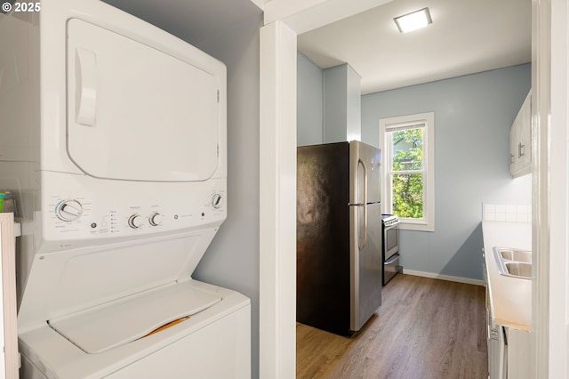1963 Villard St, Eugene, OR 97403 - laundry area with stacked washer and clothes dryer and light wood-type flooring
