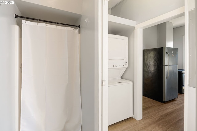 1963 Villard St, Eugene, OR 97403 - full bathroom with stacked washer / dryer, wood finished floors, and a shower with shower curtain