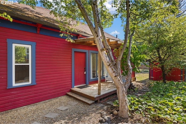 1963 Villard St, Eugene, OR 97403 - view of exterior entry with a wooden deck and a shingled roof