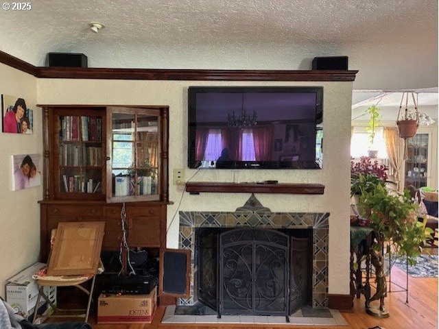 9615 NE Mason St, Portland, OR 97220 - living room with a fireplace, wood finished floors, and a textured ceiling