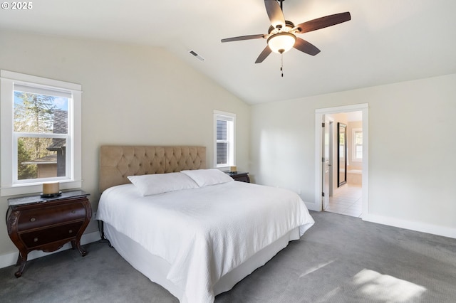 bedroom with ensuite bathroom, lofted ceiling, ceiling fan, and carpet flooring