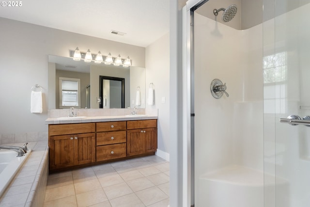 bathroom featuring tile patterned floors, separate shower and tub, and vanity