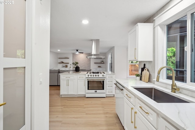 kitchen with a sink, open floor plan, wall chimney range hood, dishwasher, and gas range